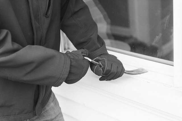 burglar using a window to enter the property